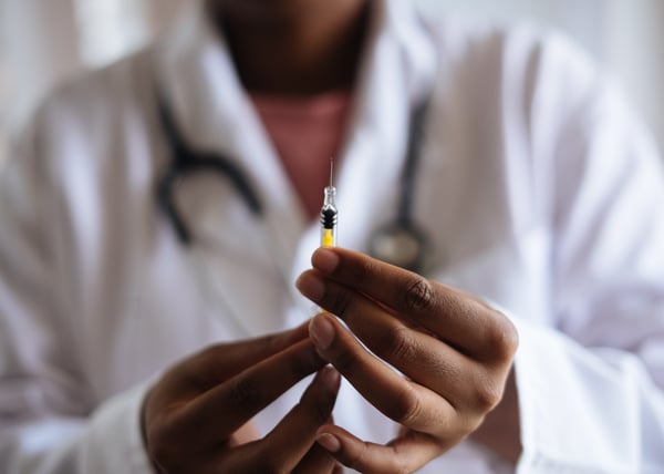 doctor with vaccine and lab coat