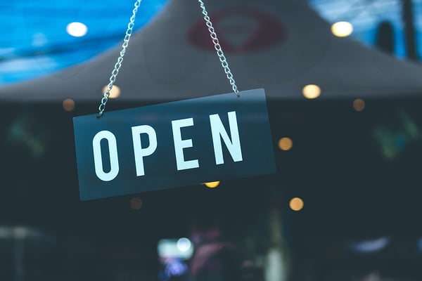 open sign hanging in a window