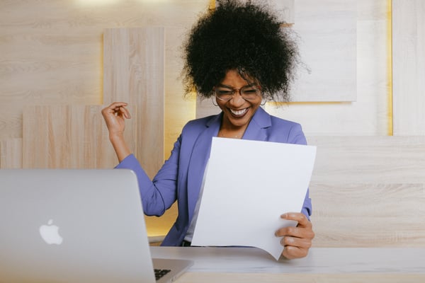 Woman with purple shirt achieving her goals